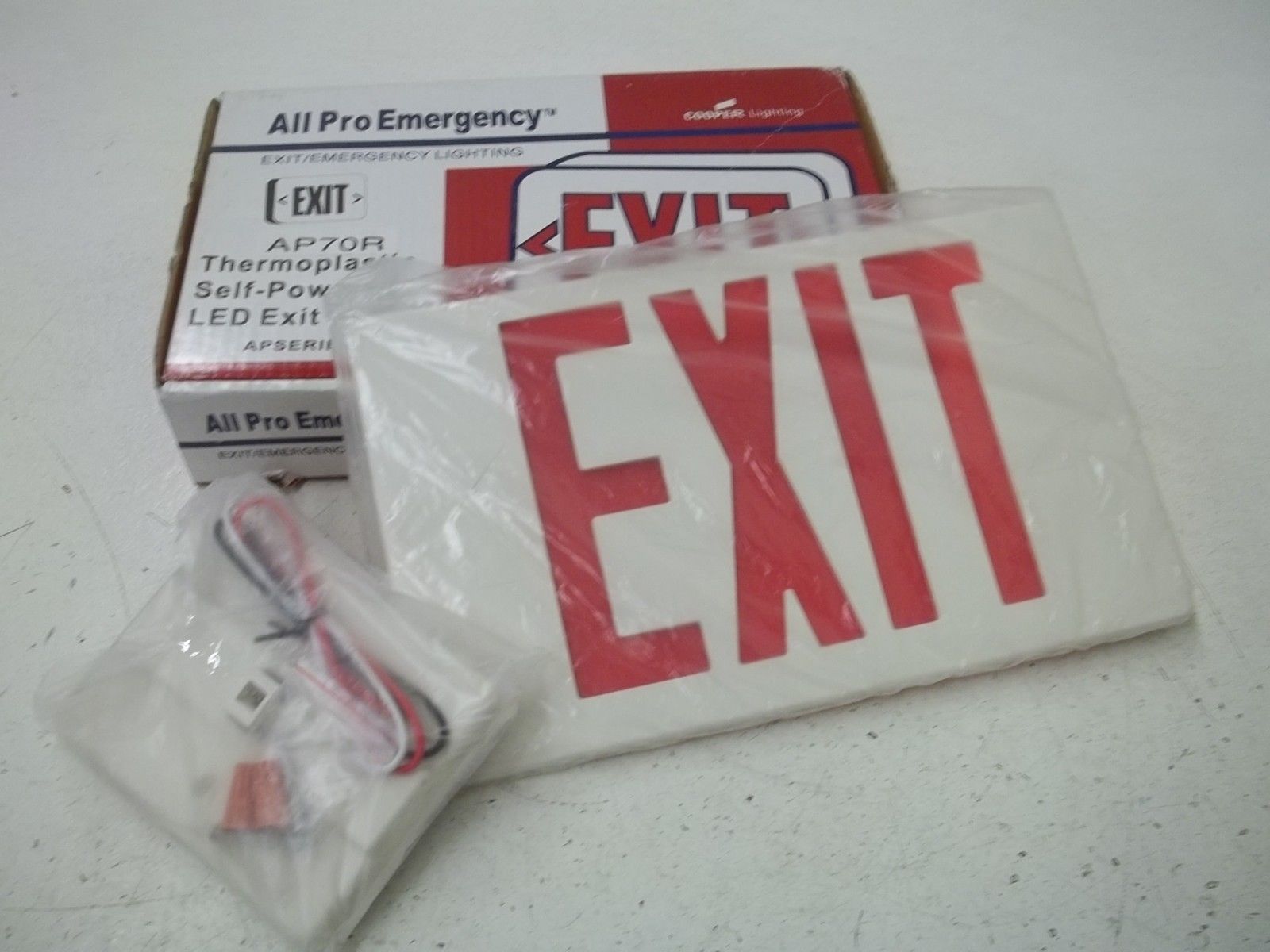 COOPER AP70R EXIT SIGN 120/277V (AS PICTURED) *NEW IN BOX*